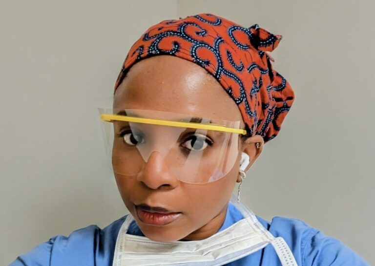 Dr. Amazing-Grace Ighedo in scrubs and safety glasses